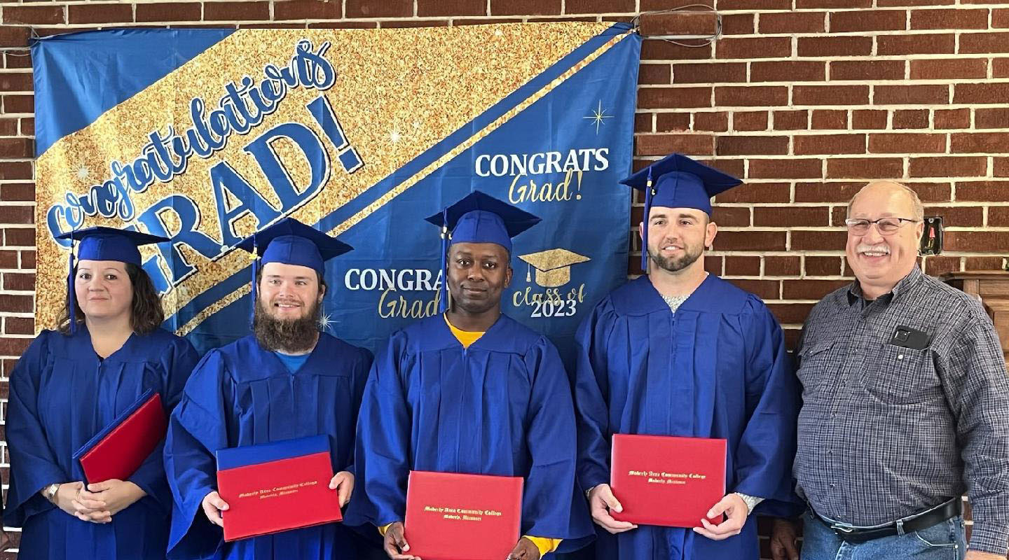 4 members of the graduating class of 2023 in their caps and gowns